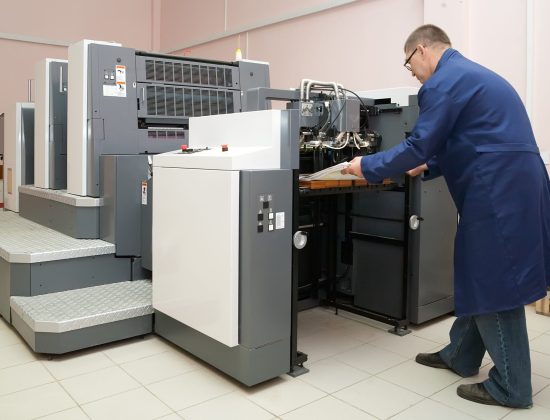 Printer working at his new offset machine